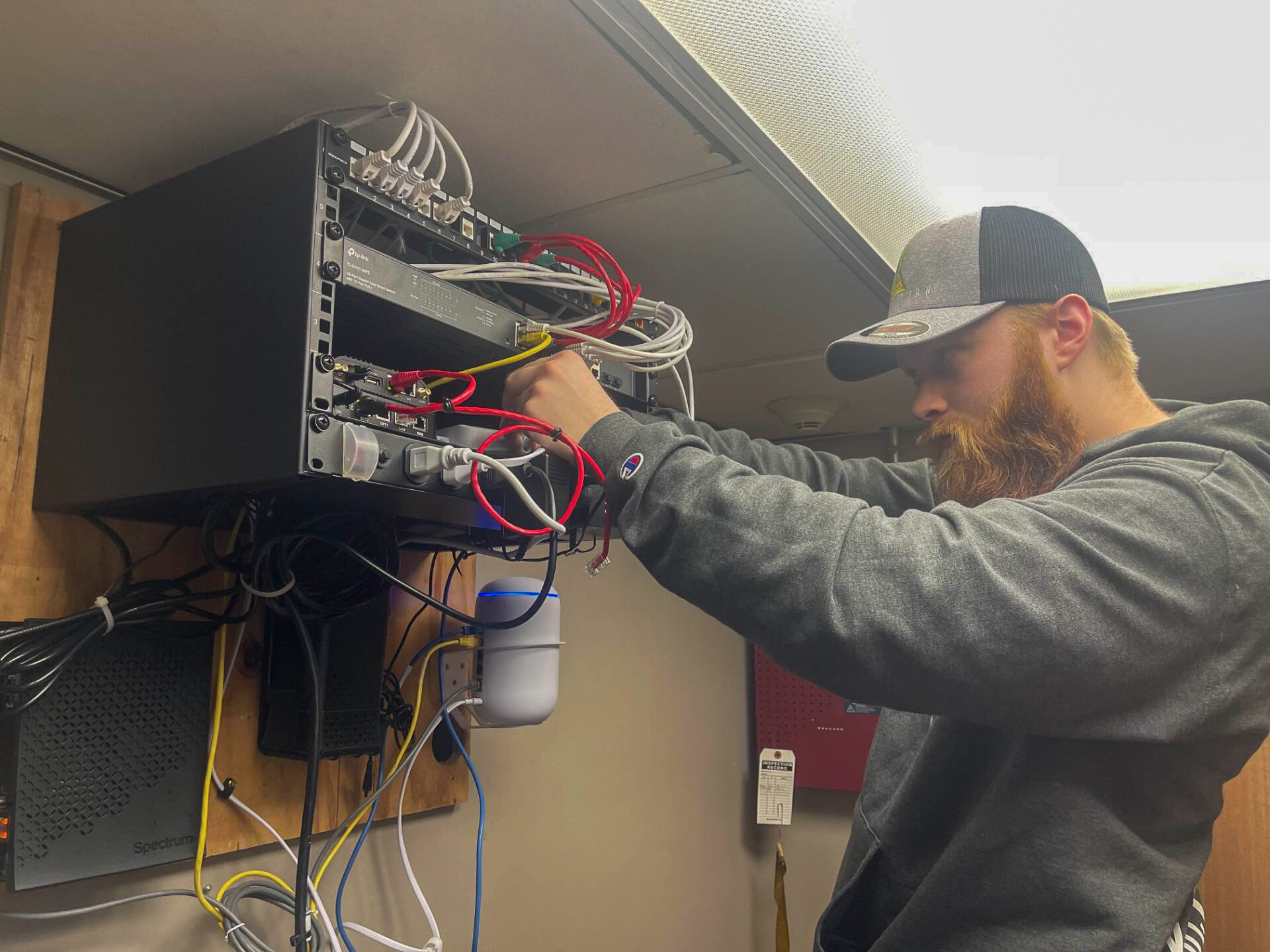 Worker installing hardware for cyber security